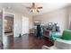 Bedroom featuring a ceiling fan, wood floors, and a large desk with multiple monitors at 1030 Wild Fern Ct, Las Vegas, NV 89183