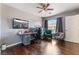 Bedroom with a large window and an elegant work station, featuring dark wood floors at 1030 Wild Fern Ct, Las Vegas, NV 89183