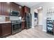 Modern kitchen with stainless steel appliances, dark wood cabinets and stylish tile backsplash at 1030 Wild Fern Ct, Las Vegas, NV 89183