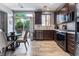 Modern kitchen with stainless steel appliances, granite countertops, and dark cabinets, perfect for cooking and entertaining at 1030 Wild Fern Ct, Las Vegas, NV 89183