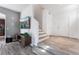 Bright living area with wood flooring, staircase, and a stylish television on the wall at 1030 Wild Fern Ct, Las Vegas, NV 89183