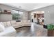 Open-concept living room with hardwood floors, a comfortable sofa, and views into the modern kitchen at 1030 Wild Fern Ct, Las Vegas, NV 89183
