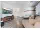 Bright living room featuring hardwood floors, comfortable sectional sofa, and stylish media console at 1030 Wild Fern Ct, Las Vegas, NV 89183