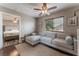 Comfortable living room area adjacent to a bedroom, featuring a plush gray sectional couch at 1030 Wild Fern Ct, Las Vegas, NV 89183