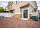 View of the fenced backyard with rock landscaping, sliding glass doors, and exterior of the home at 1156 Harts Bluff Pl # 3, Henderson, NV 89002