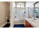 Bathroom with combination shower and tub featuring a vanity with a white sink and dark wood cabinets at 1156 Harts Bluff Pl # 3, Henderson, NV 89002