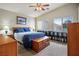 Bright bedroom with a ceiling fan, neutral walls, carpet flooring and a wooden dresser with book shelves at 1156 Harts Bluff Pl # 3, Henderson, NV 89002