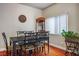 Cozy dining room with a wooden table, six chairs, and natural lighting from the window at 1156 Harts Bluff Pl # 3, Henderson, NV 89002
