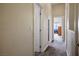 Hallway featuring carpeted floors and white doors, leading to various rooms in the home at 1156 Harts Bluff Pl # 3, Henderson, NV 89002