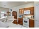 Well-lit kitchen with a large countertop, white appliances, and a view into the living space at 1156 Harts Bluff Pl # 3, Henderson, NV 89002