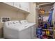 Functional laundry room with a washer, dryer, and shelving for storage at 1156 Harts Bluff Pl # 3, Henderson, NV 89002