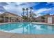 Community pool area featuring a pool, lounge chairs, palm trees and a cabana at 1156 Harts Bluff Pl # 3, Henderson, NV 89002