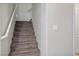 Carpeted staircase with white handrail, providing access to the upper level of the home at 1156 Harts Bluff Pl # 3, Henderson, NV 89002