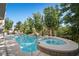 Inviting backyard showcasing a pool, spa, lush landscaping and outdoor seating, creating a serene oasis at 12125 Edgehurst Ct, Las Vegas, NV 89138