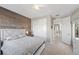 Well-lit bedroom with wood accent wall, neutral carpet, and closet with white doors at 12125 Edgehurst Ct, Las Vegas, NV 89138