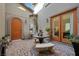 Picturesque courtyard featuring a dining set, sculpture, and serene ambiance at 12125 Edgehurst Ct, Las Vegas, NV 89138