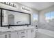 Bathroom with a marble countertop, backsplash, and bathtub at 1216 Padre Serra Ln, Las Vegas, NV 89134