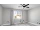 Bright bedroom featuring a ceiling fan, wood-look floors, and large windows at 1216 Padre Serra Ln, Las Vegas, NV 89134