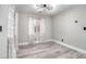 Bedroom with neutral walls, window with patterned curtains and wood-style floor at 1216 Padre Serra Ln, Las Vegas, NV 89134