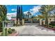 Beautiful gated community entrance with lush landscaping and ornate ironwork at 1216 Padre Serra Ln, Las Vegas, NV 89134