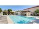 Community pool with lounge chairs and pergola, perfect for relaxing in the sun at 1216 Padre Serra Ln, Las Vegas, NV 89134