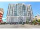 Modern high-rise apartment building with a sleek design, multiple windows, and street-level access in a bustling area at 150 Las Vegas Blvd # 1014, Las Vegas, NV 89101