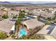 An aerial view of a well-maintained backyard pool, desert landscaping, and a neighborhood street at 1532 Via Cassia, Henderson, NV 89052