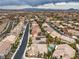 Expansive aerial view of a neighborhood featuring well-maintained homes and landscaping with mountain views at 1532 Via Cassia, Henderson, NV 89052