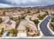 Aerial view of a home with a three-car garage, solar panels, pool, and well-maintained landscaping at 1532 Via Cassia, Henderson, NV 89052
