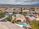 Aerial view showcasing a backyard pool and spa with desert landscaping and mountain backdrop at 1532 Via Cassia, Henderson, NV 89052