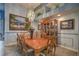 Elegant dining room with chandelier, light blue walls, and large wood table at 1532 Via Cassia, Henderson, NV 89052
