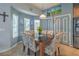 Bright dining room featuring a modern chandelier, blue paneled doors, and a glass-top table at 1532 Via Cassia, Henderson, NV 89052