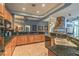Well-lit kitchen featuring custom wood cabinetry, granite countertops, and modern appliances at 1532 Via Cassia, Henderson, NV 89052