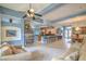 Bright, open living area features stone fireplace and seamless flow to kitchen and dining at 1532 Via Cassia, Henderson, NV 89052