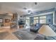 Bright living room with a stone fireplace, large windows, and comfortable seating at 1532 Via Cassia, Henderson, NV 89052