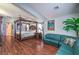 Bright main bedroom with a four-poster bed, hardwood floors, and plenty of space at 1532 Via Cassia, Henderson, NV 89052