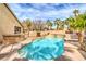 Backyard pool with clear water, palm trees, and a poolside lounge area at 1532 Via Cassia, Henderson, NV 89052
