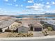 Magnificent aerial view of a single-story home with a lake view, and modern desert landscape at 160 Stone Mesa Ct, Henderson, NV 89011