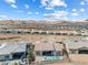 Expansive aerial view of a desert community featuring single-story homes and a serene mountain backdrop at 160 Stone Mesa Ct, Henderson, NV 89011