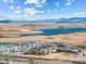 Scenic aerial view featuring homes in a lakeside community with mountain views in the distance at 160 Stone Mesa Ct, Henderson, NV 89011