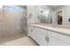 Modern bathroom features a spacious glass shower and dual vanities with modern fixtures at 160 Stone Mesa Ct, Henderson, NV 89011