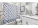 This bathroom features a shower/tub combo with a decorative curtain, a toilet, and a single sink vanity with ample storage at 160 Stone Mesa Ct, Henderson, NV 89011