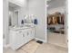 Elegant bathroom with double sinks, a large mirror, and a walk-in closet at 160 Stone Mesa Ct, Henderson, NV 89011