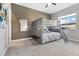 This carpeted bedroom has a bunk bed, a mirror, a window with a neighborhood view, and light gray walls at 160 Stone Mesa Ct, Henderson, NV 89011