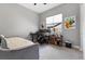 This bedroom features a work space, a bed, a window with a neighborhood view, and neutral walls at 160 Stone Mesa Ct, Henderson, NV 89011
