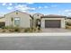 A delightful single-story home featuring a two-car garage, a xeriscaped front yard, and desert landscaping at 160 Stone Mesa Ct, Henderson, NV 89011