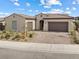 Well-maintained single-story home featuring a two-car garage and xeriscaped front yard at 160 Stone Mesa Ct, Henderson, NV 89011