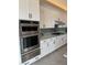 Modern kitchen featuring white cabinets, stainless steel appliances, and gray countertops at 160 Stone Mesa Ct, Henderson, NV 89011