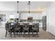 Modern kitchen with bar seating, pendant lighting, and stainless steel appliances at 160 Stone Mesa Ct, Henderson, NV 89011