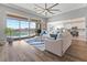 Bright living room with hardwood floors and sliding glass doors to a pool at 160 Stone Mesa Ct, Henderson, NV 89011